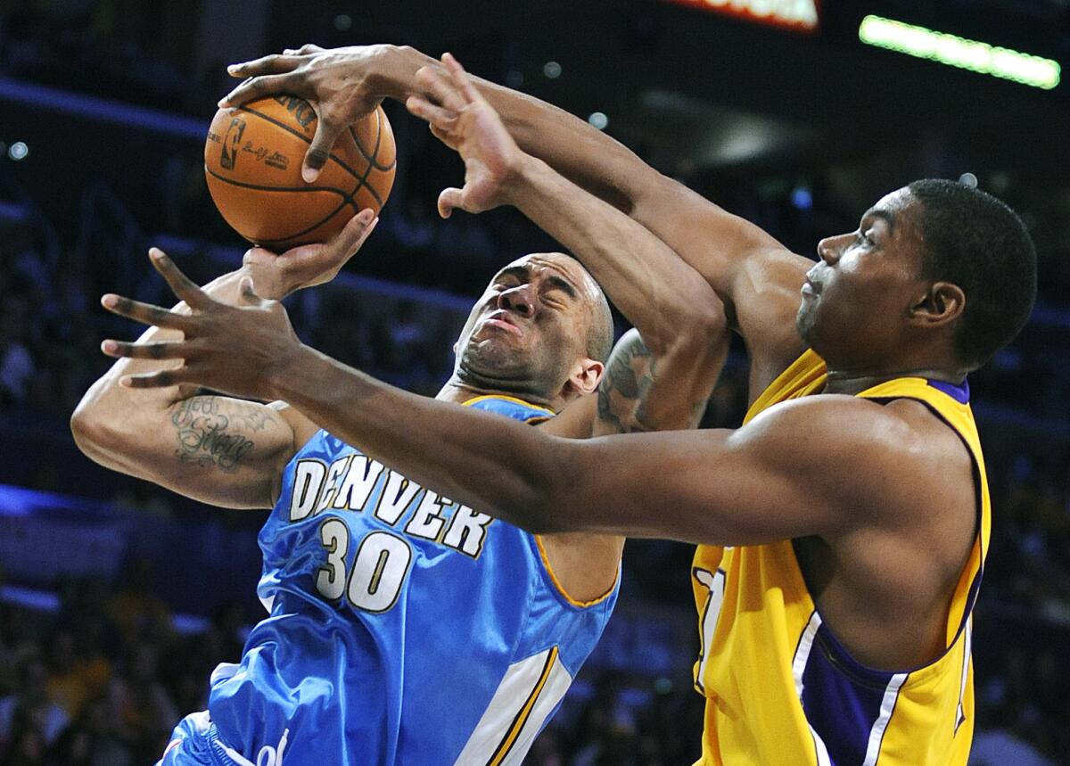 Nuggets swing man Dahntay Jones is blocked by Lakers center Andrew Bynum during a game on May 27, 2009.