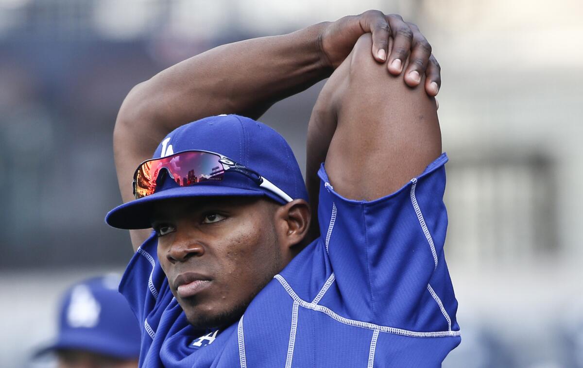 Dodgers outfielder Yasiel Puig stretches before a game against the San Diego Padres on April 24.