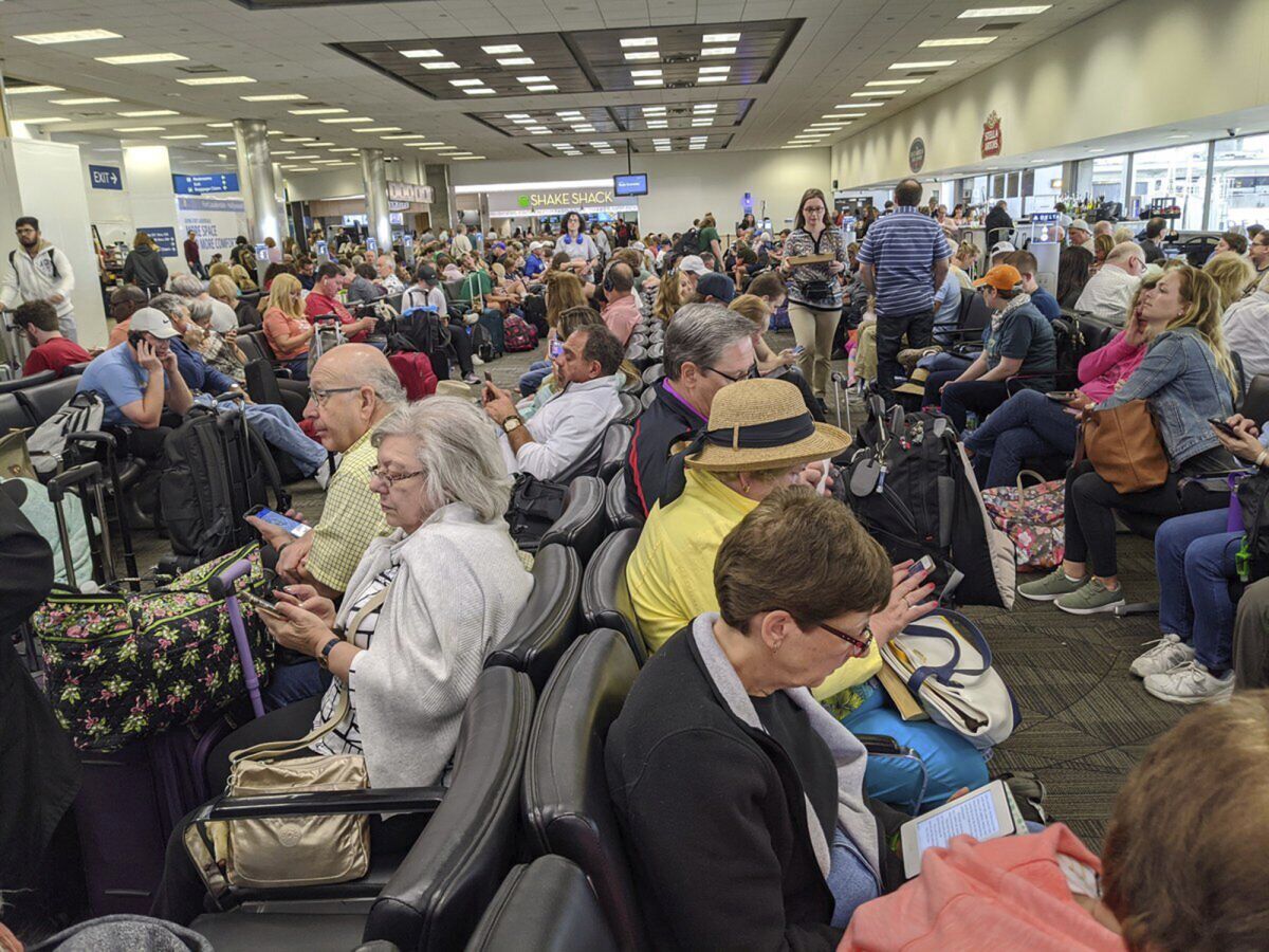 A gate area at Fort Lauderdale-Hollywood International Airport is crowded with travelers.