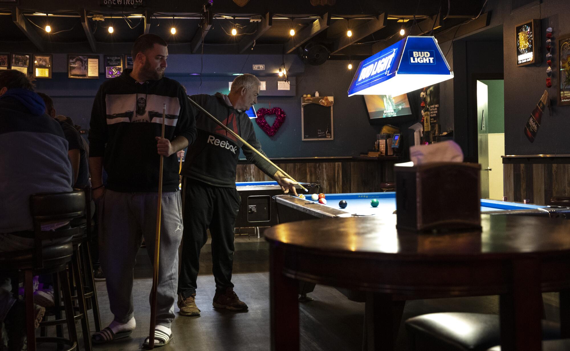 Men play billiards in the Tangle Blue Saloon Monday, Jan. 31, 2022 in Trinity County, CA