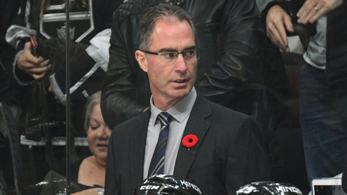 Former Kings coach John Stevens, center, looks on during a game against the Tampa Bay Lightning on Nov. 9, 2017. The Kings have relieved Stevens from his duties on Sunday.