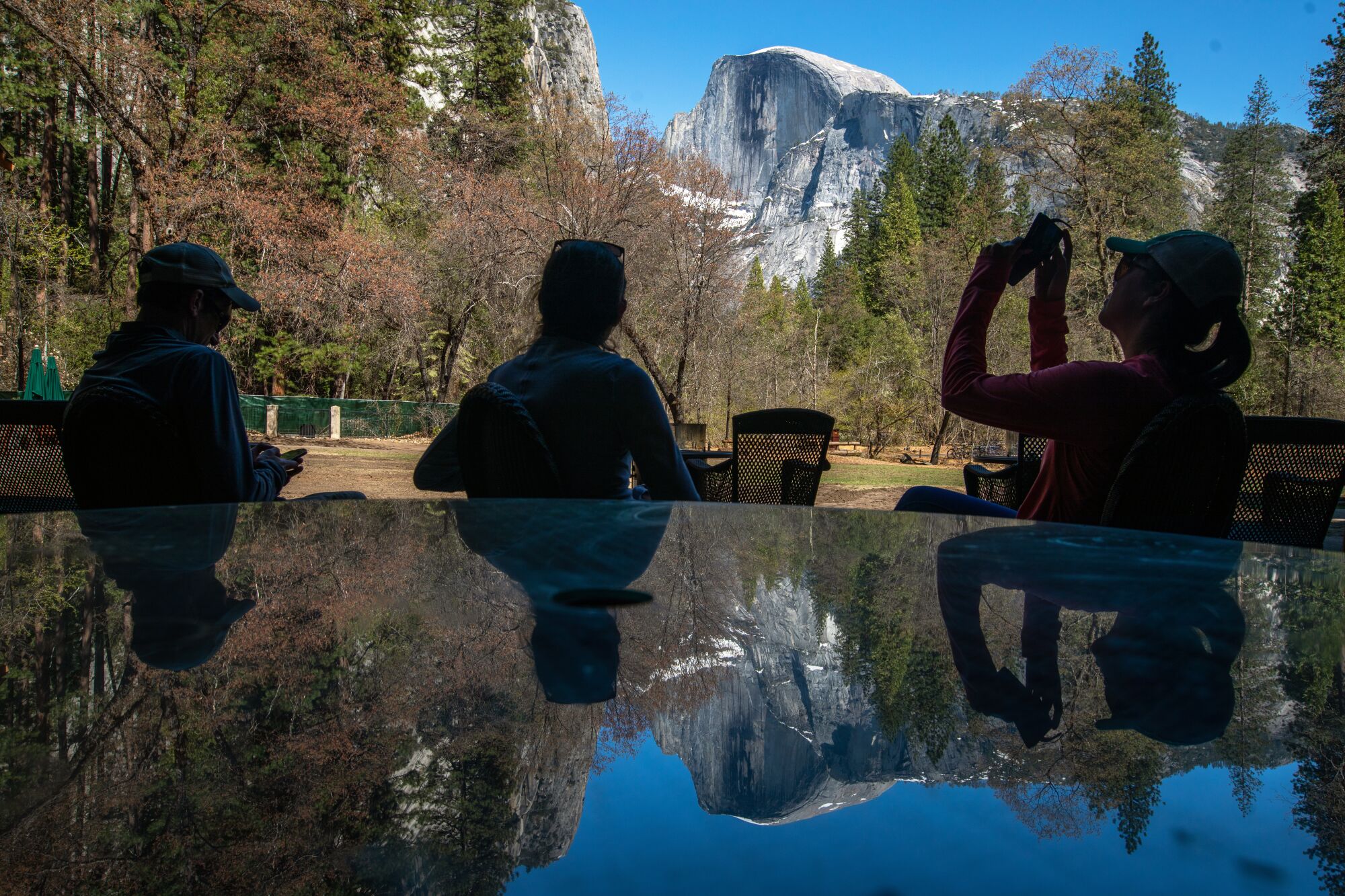 A few people stop by the patio at the 95-year-old Ahwahnee Hotel on Friday, April 28, 2023, in Yosemite National Park, CA. 