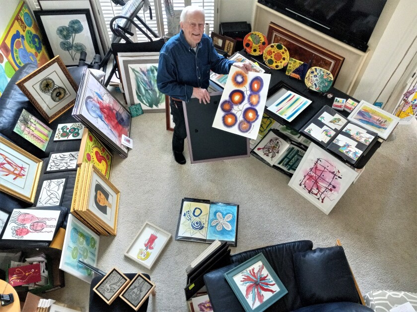 Coop Cooprider stands with a collection of art by his late wife, La Jollan Patti Cooprider.