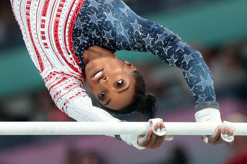 PARIS, FRANCE July 30, 2024-USA's Simone Biles competes on the uneven bars in the women's gymnastics team final at the 2024 Olympics in Paris, France Tuesday. (Wally Skalij/Los Angeles Times)