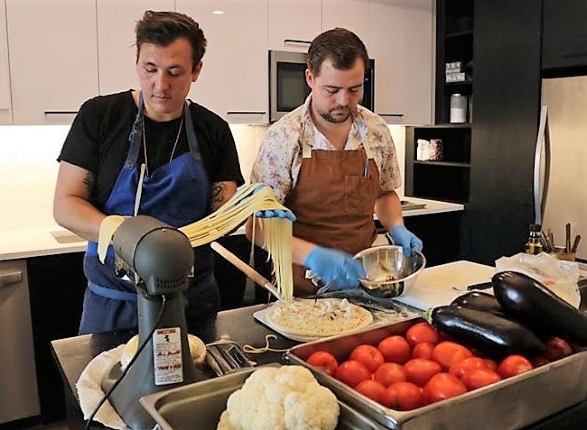Chefs Chris Gentile, left, and Brandon Sloan making pasta for their furlough-driven startup Pandemic Pizza, which has sold more than 200 pizzas since launching on Instagram two weeks ago.