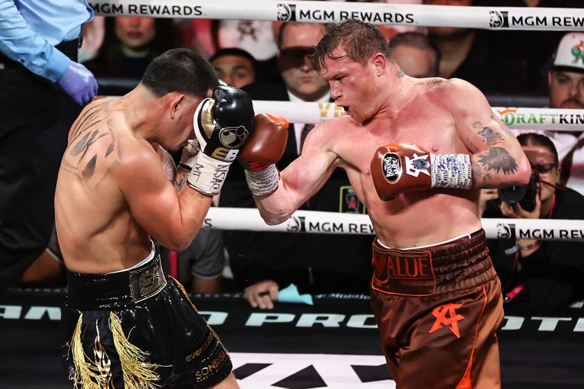 LAS VEGAS, NEVADA - SEPTEMBER 14: Saul Canelo Alvarez (R) punches Edgar Berlanga.