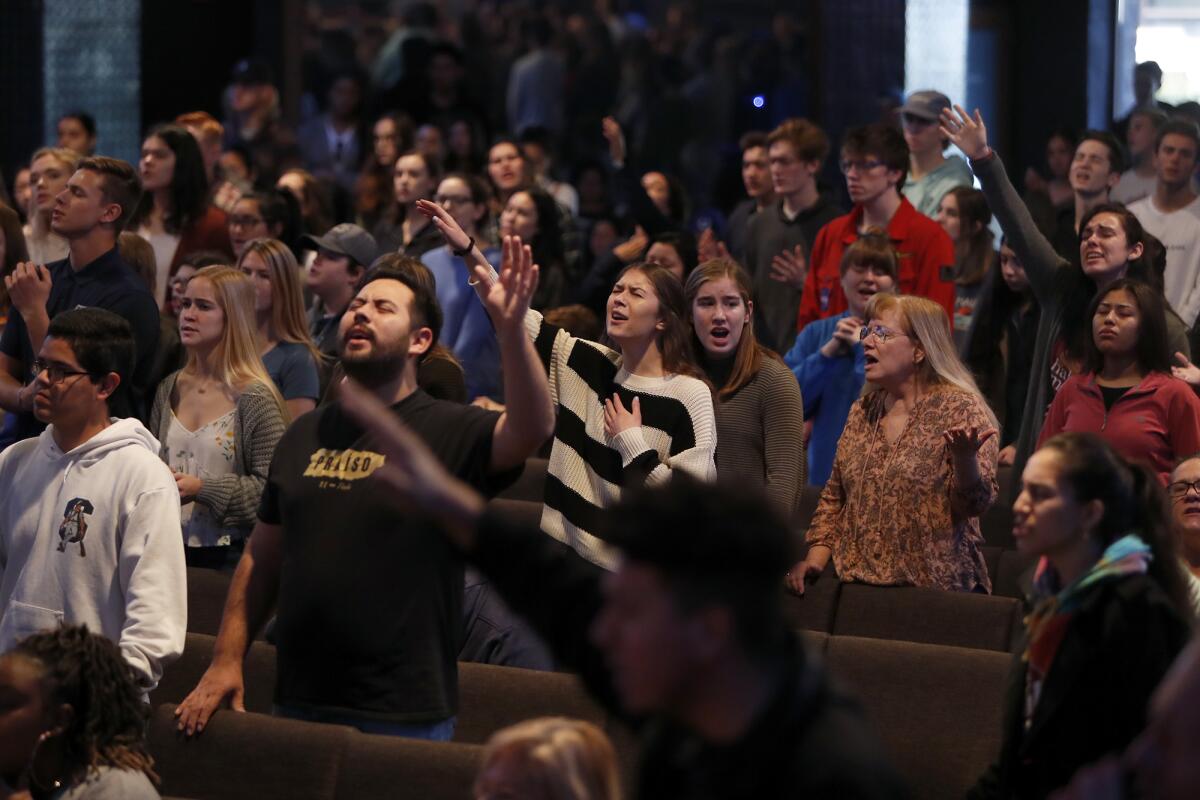 Vanguard University students and faculty worship Thursday at the annual Pray for Freedom event to end human trafficking at Newport Mesa Church in Costa Mesa.