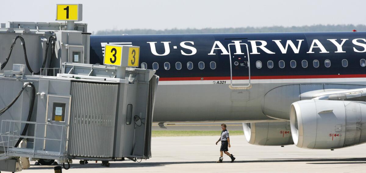 A US Airways plane sits next to the terminal at Will Rogers World Airport in 2006 after it was diverted to Oklahoma City because of an incident involving a disruptive passenger.