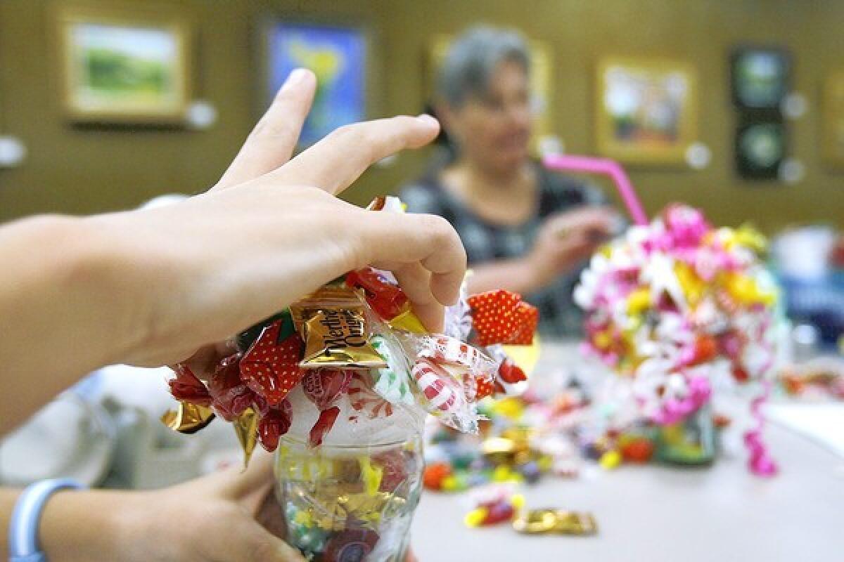 Youths make candy sundae bouquets at the La Canada Public Library on Tuesday, July 9, 2013.