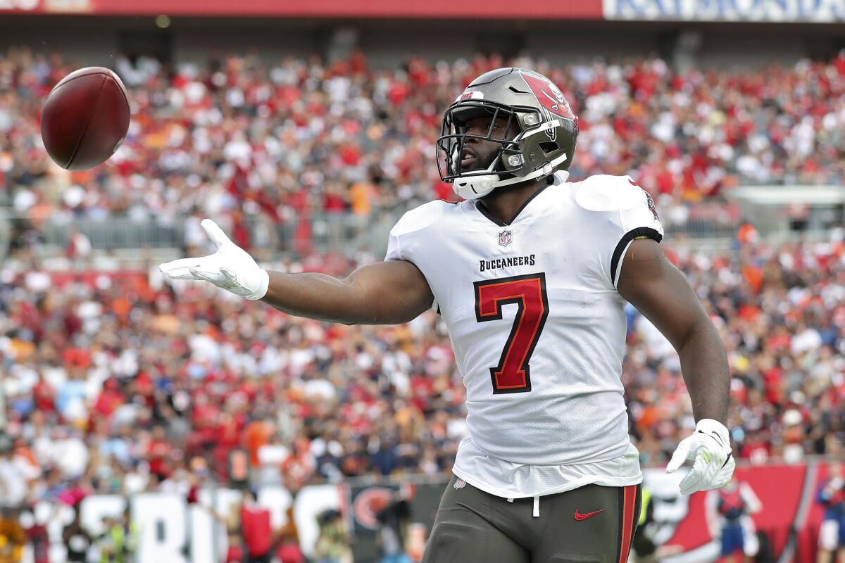 Tampa Bay Buccaneers running back Leonard Fournette (7) throws the ball to a fan after his touchdown run against the Chicago Bears during the first half of an NFL football game Sunday, Oct. 24, 2021, in Tampa, Fla. (AP Photo/Mark LoMoglio)
