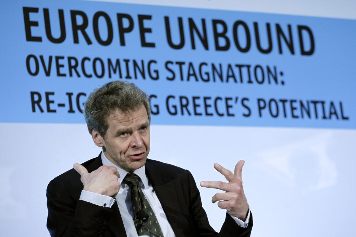 The International Monetary Fund's troika representative to Greece, Poul Thomsen, speaks during a conference on the economy in central Athens on Monday. Greece cleared a key hurdle in its drive to receive its next batch of bailout loans after international debt inspectors said Monday they had reached an agreement over the country's economic reforms, including the firing of civil servants.