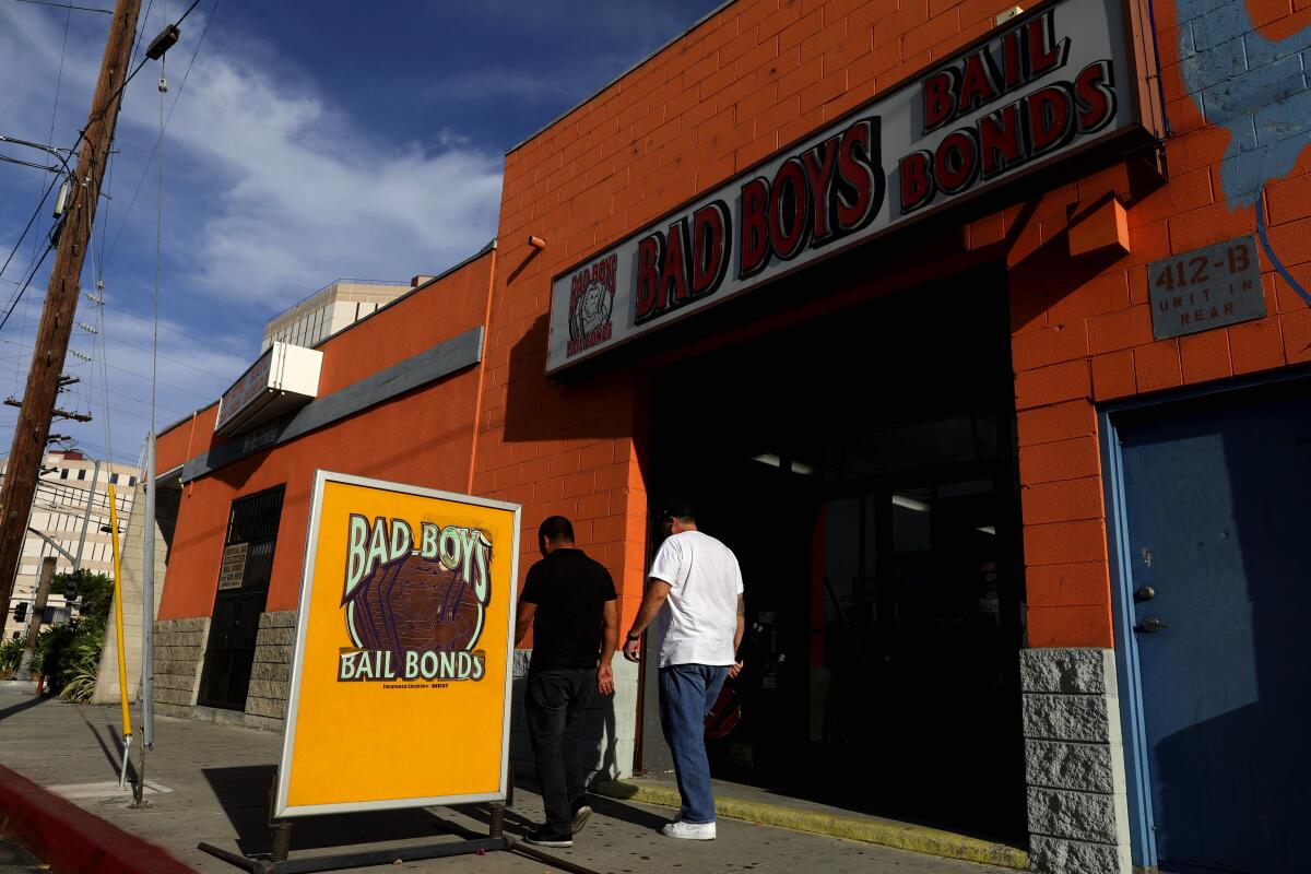 A sign reads "Bad Boys Bail Bonds" outside a storefront