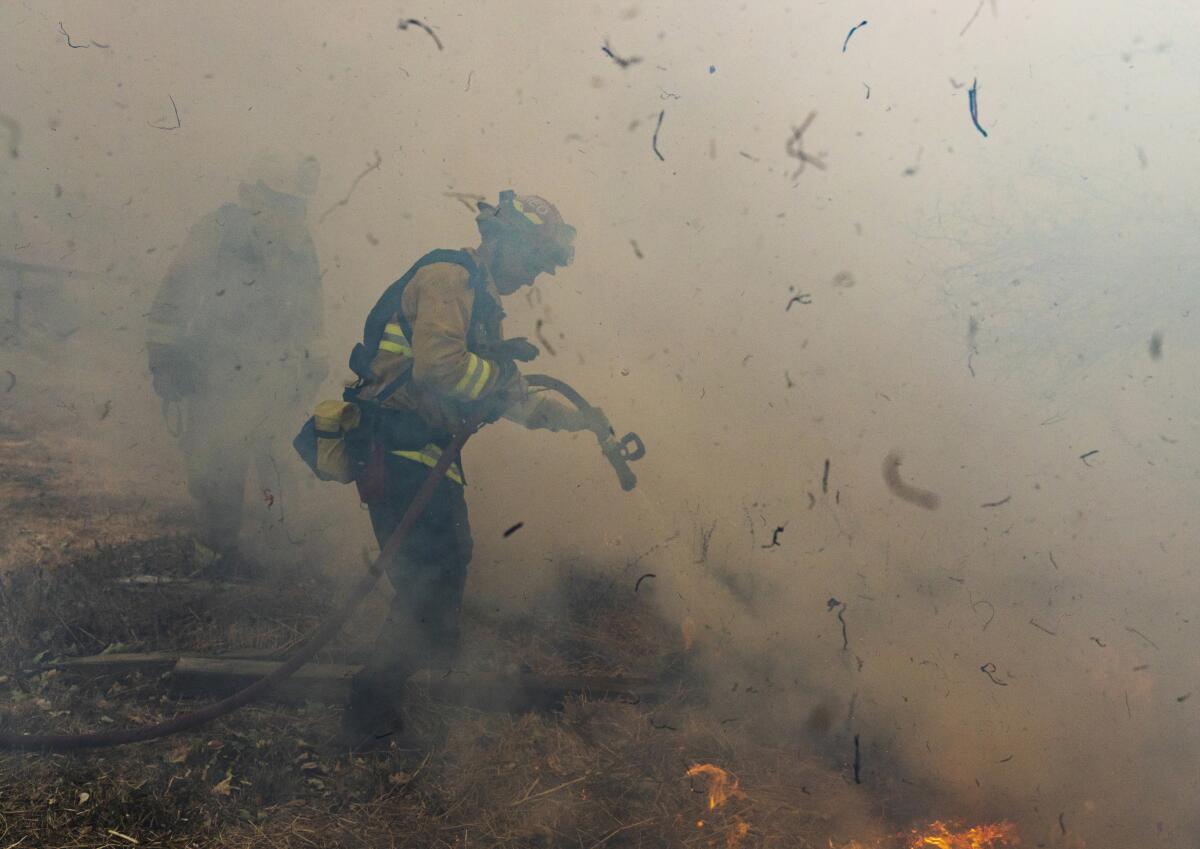 Firefighters from San Mateo battle the Kincade fire Oct. 27 in Sonoma County.