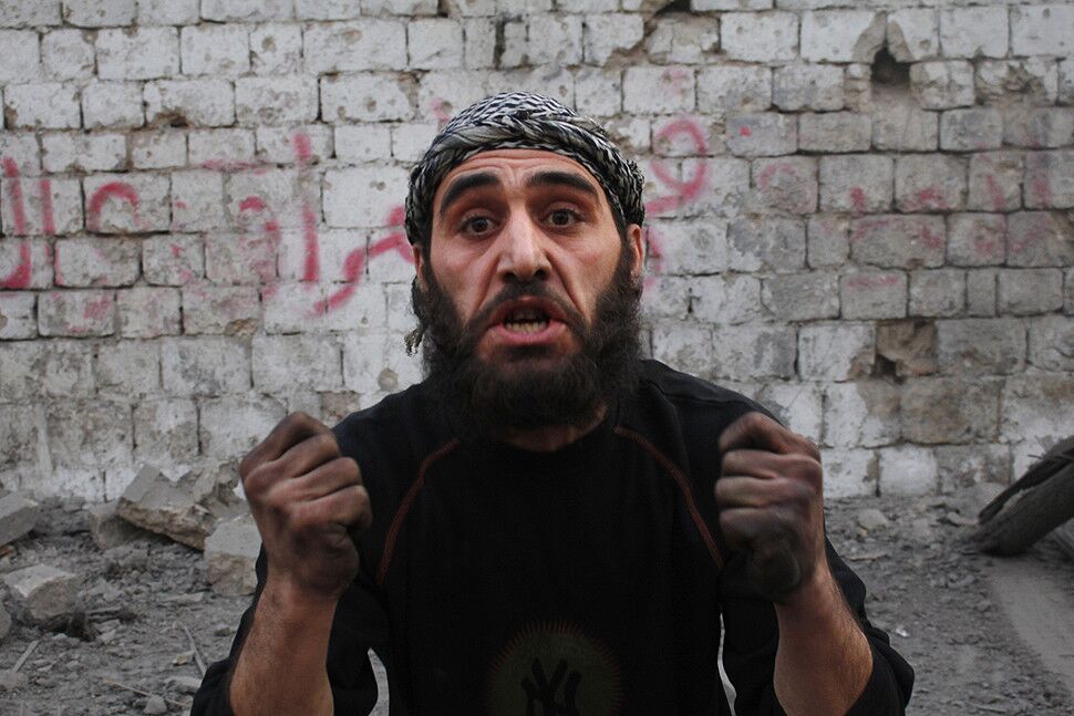A Syrian man reacts after an airstrike by government forces on the city of Aleppo.