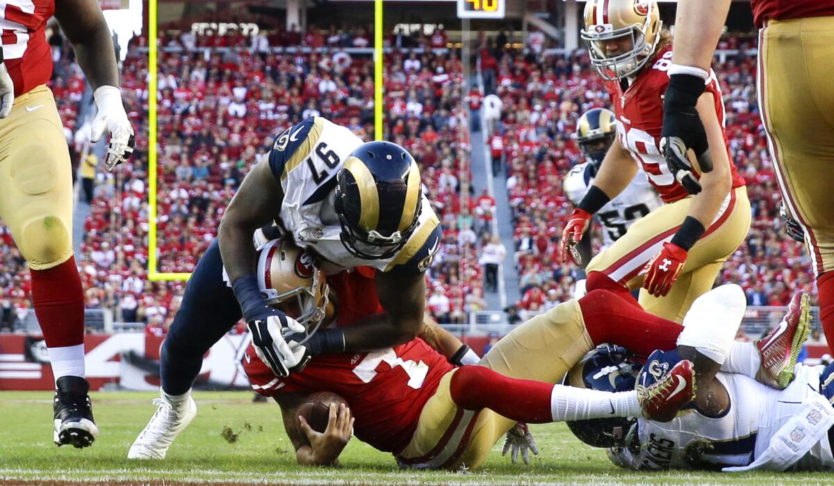 Rams defensive linemen Eugene Sims (97) and Michael Brockers (90) sack 49ers quarterback Colin Kaepernick during a game at Levi's Stadium on Nov. 2.