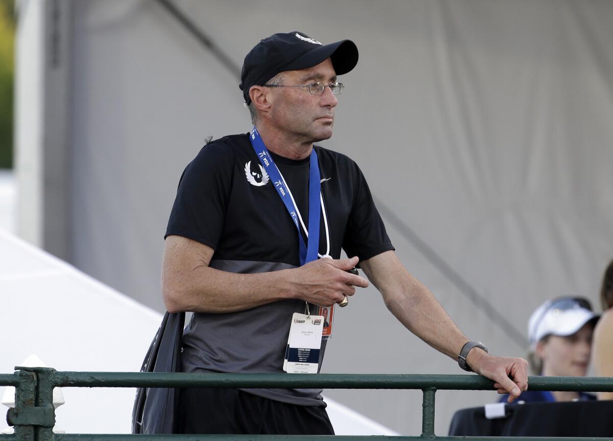 FILE - In this June 25, 2015, file photo, Alberto Salazar watches a race at the U.S. track and field championships in Eugene, Ore. Track coach Salazar received no relief from the Court of Arbitration for Sport, which upheld his four-year ban for a series of doping-related violations that had long been pursued by American regulators. A person familiar with the decision told The Associated Press on Wednesday, Sept. 15, 2021, that the bans for both Salazar and endocrinologist Jeffrey Brown, first passed down in 2019, had been upheld. The person did not want to be identified because CAS has not yet released the full report, which is expected soon. (AP Photo/Don Ryan, File)