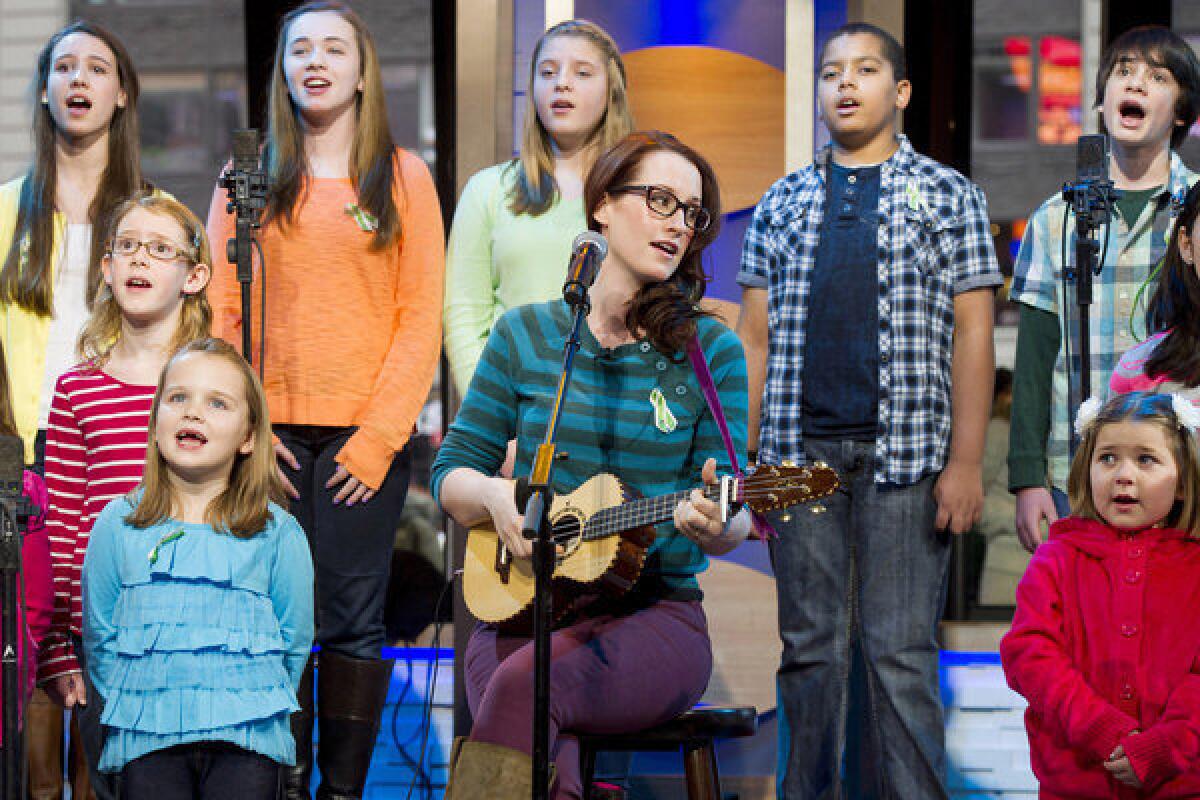 Singer Ingrid Michaelson, center, has joined students from Sandy Hook Elementary School to record the benefit single "Somewhere Over the Rainbow."