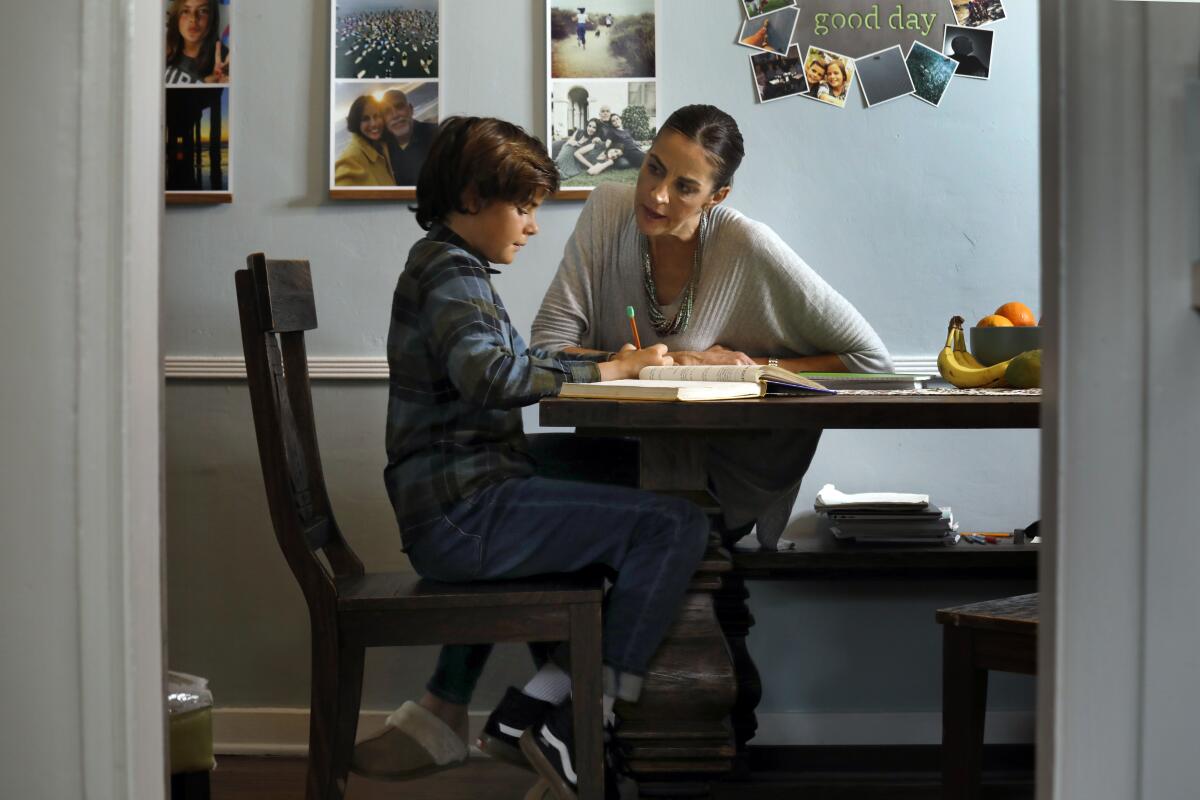 Karen Mozian home schools her sixth-grade son, Elijah, 9, at their home in Redondo Beach.