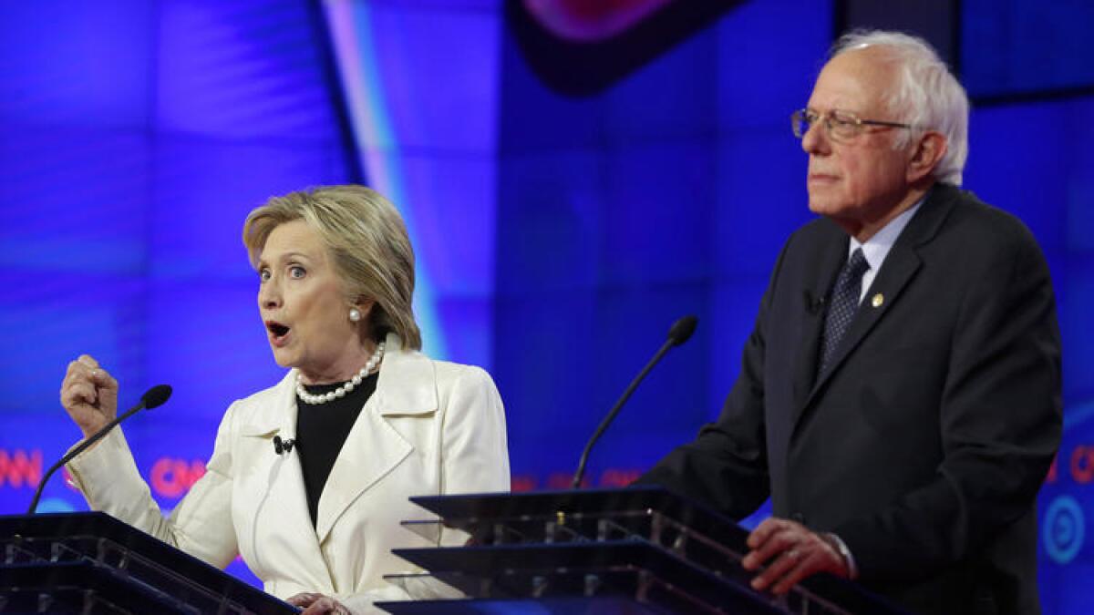 Hillary Clinton and Bernie Sanders participate in Thursday's Democratic presidential debate in Brooklyn, N.Y.