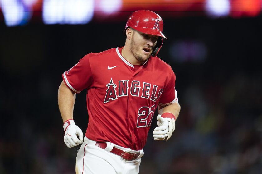 Los Angeles Angels' Mike Trout (27) runs the bases after hitting a home run during the seventh inning.