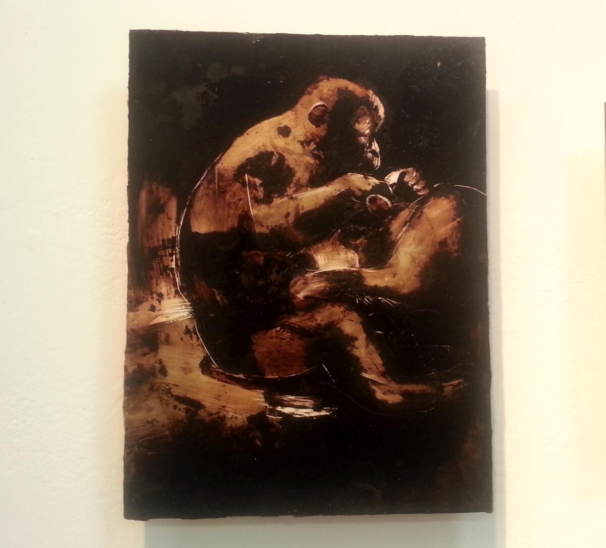 A painting of a pair of monkeys by James Griffith at Craig Krull Gallery in Santa Monica. Griffith used tar from the La Brea Tar Pits to create the work.