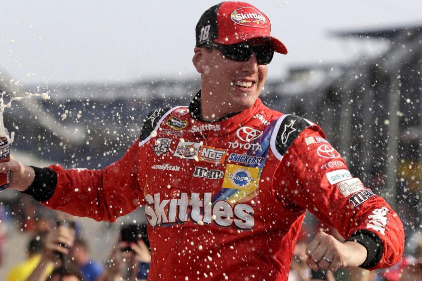 NASCAR driver Kyle Busch celebrates after winning the Sprint Cup Brickyard 400 at Indianapolis Motor Speedway.