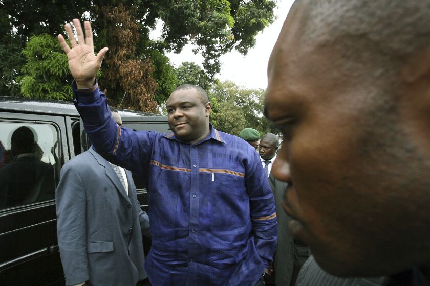 FILE- Former militia leader Jean Pierre Bemba waves at supporters as he arrives at a polling station to cast his ballot in the presidential elections in Kinshasa, Congo, Oct. 29, 2006. Bemba was appointed as Congo's defense minister Thursday March 23, 2023, amid a cabinet reshuffle. (AP Photo/Jerome Delay, file)