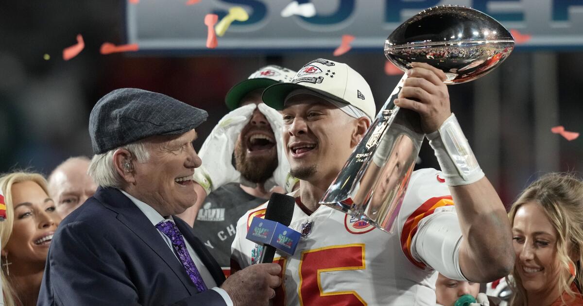 A Kansas City Chiefs fan wearing a head dress tries to get the attention of  a player before the Chiefs-Arizona Cardinals game at the University of  Phoenix Stadium in Glendale, December 7