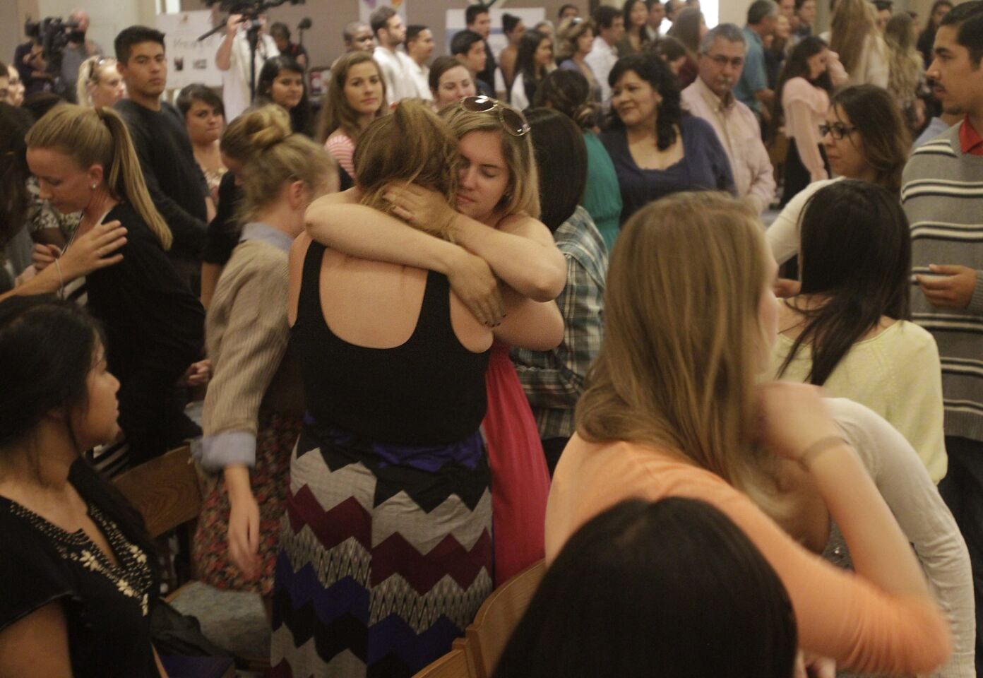 Congregants embrace during Mass at St. Mark's University Parish in Isla Vista to remember the victims of Friday night's violent rampage that left seven dead.