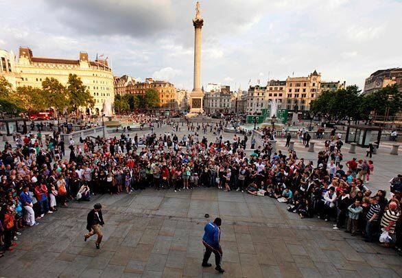 Michael Jackson fans watch as a dance is performed in his memory in central London's Trafalgar Square.