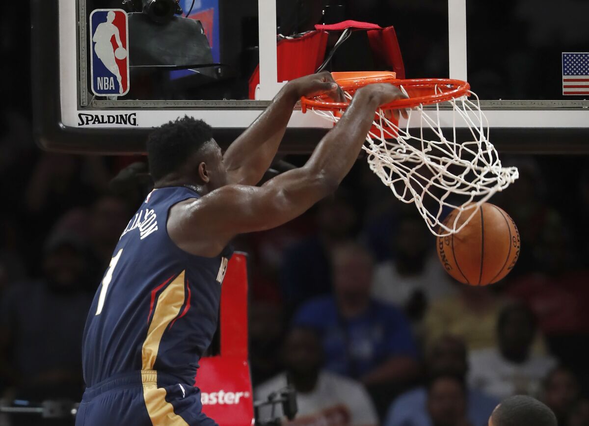 Pelicans forward Zion Williamson throws down a dunk against the Hawks during the first half Monday.