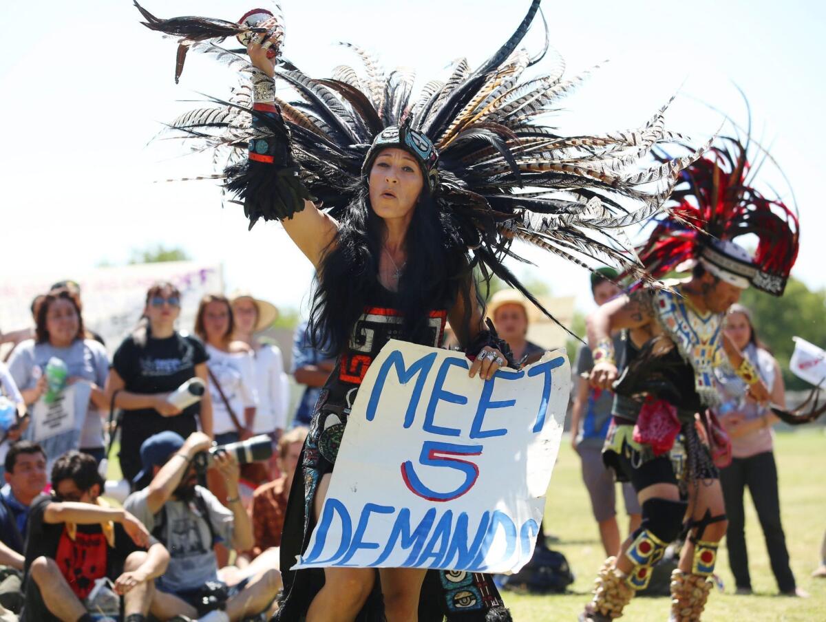 Yolanda Santoya from the Los Angeles dance group La Cuauhtemoc performs the opening ceremony before a large group marches to Corcoran State Prison in support of prison inmates holding a statewide hunger strike.