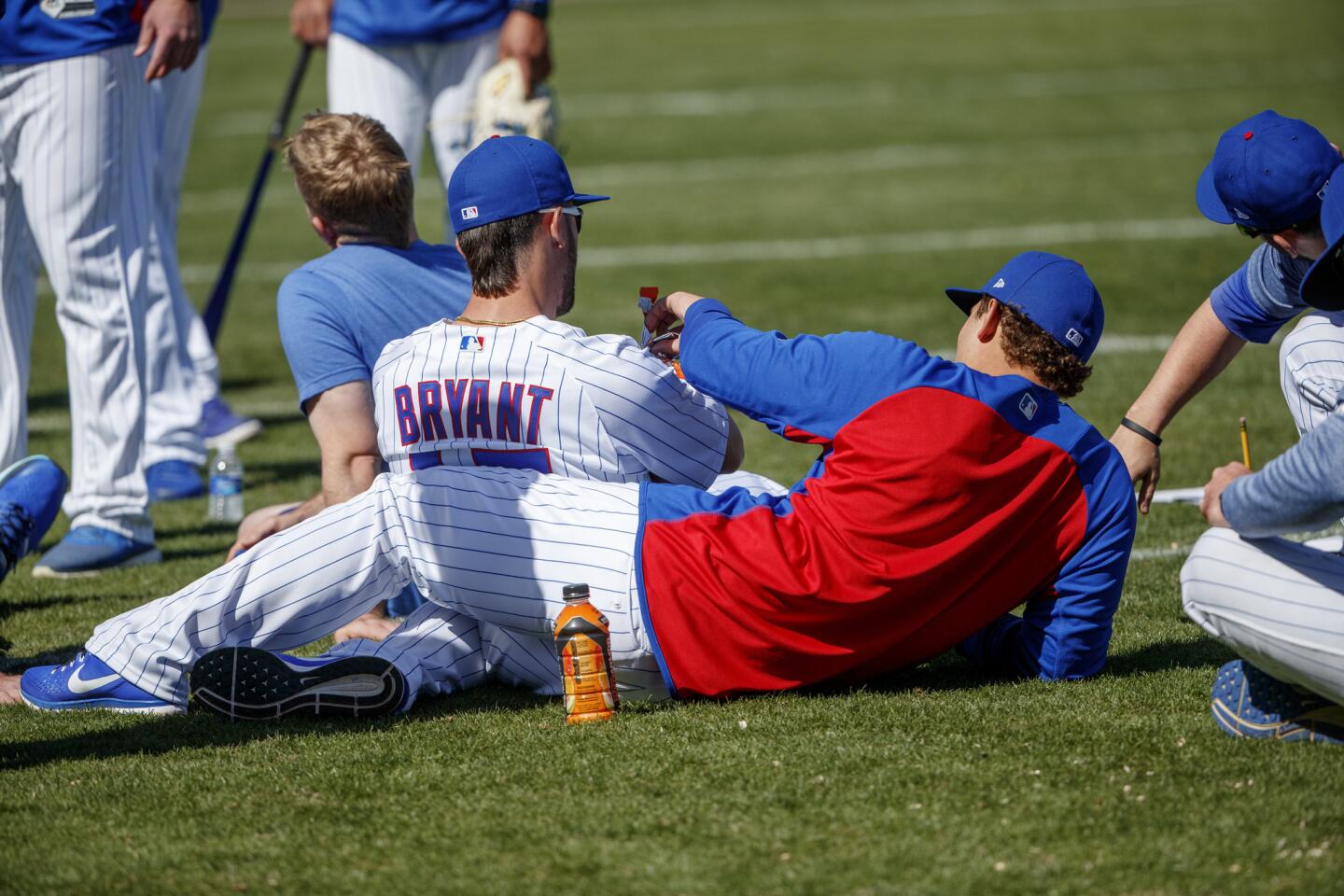 Kris Bryant rests against Anthony Rizzo after practice during Cubs spring training at Sloan Park on Feb. 20, 2018.