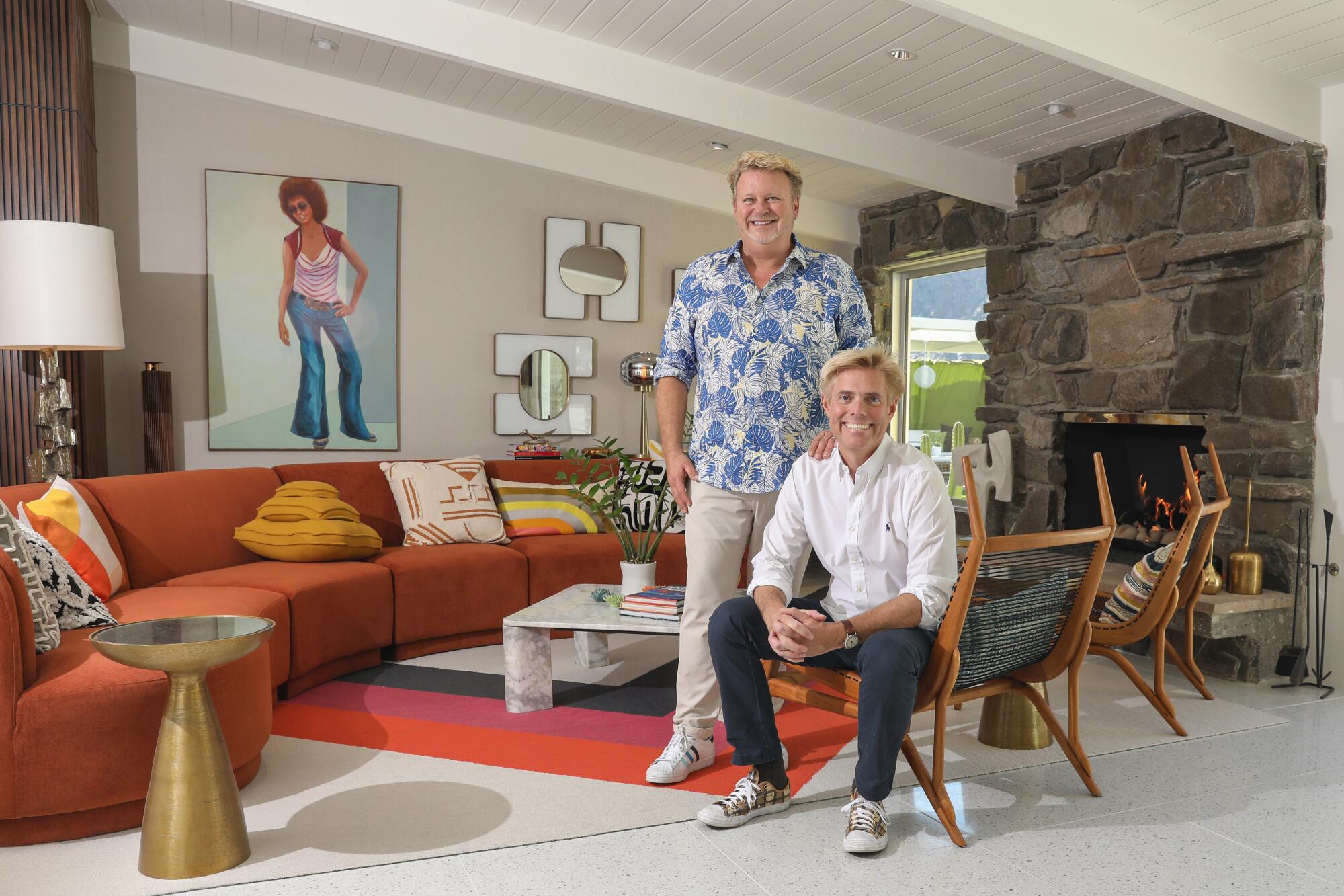 Interior designers Kevin Kemper and Howard Hawkes sitting in a living room.