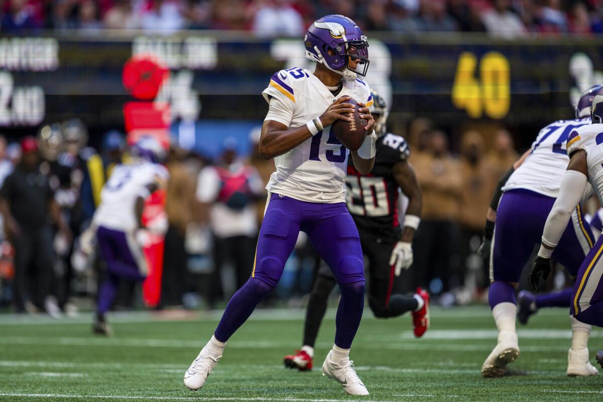 Minnesota Vikings quarterback Joshua Dobbs (15) sets to pass against the Atlanta Falcons.