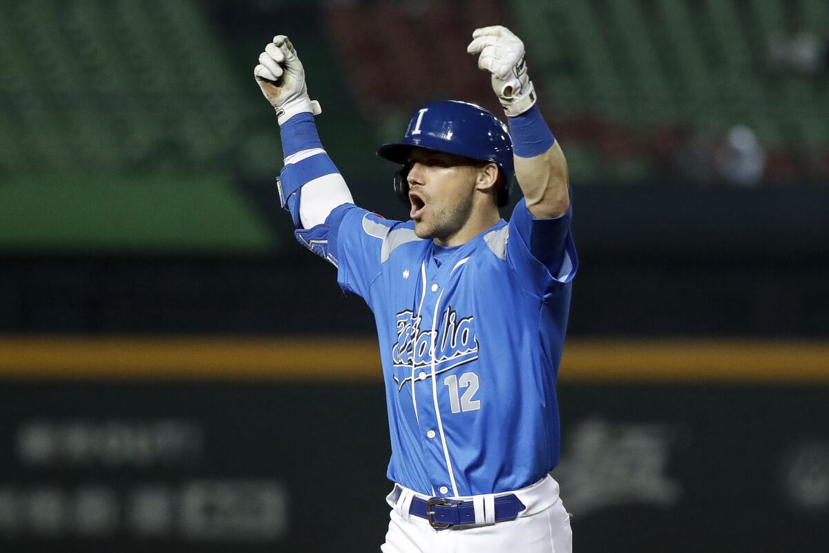 Italy Brett Sullivan cheers to his teammates during the fifth inning of a Pool A game against the Netherlands,