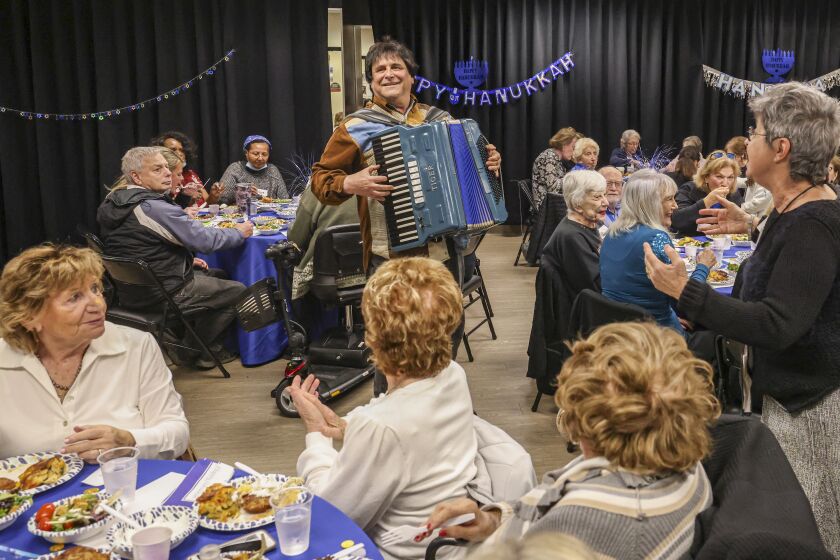 An accordionist entertains the crowd at a Hanukkah celebration at The Lawrence Family Jewish Community Center in La Jolla.