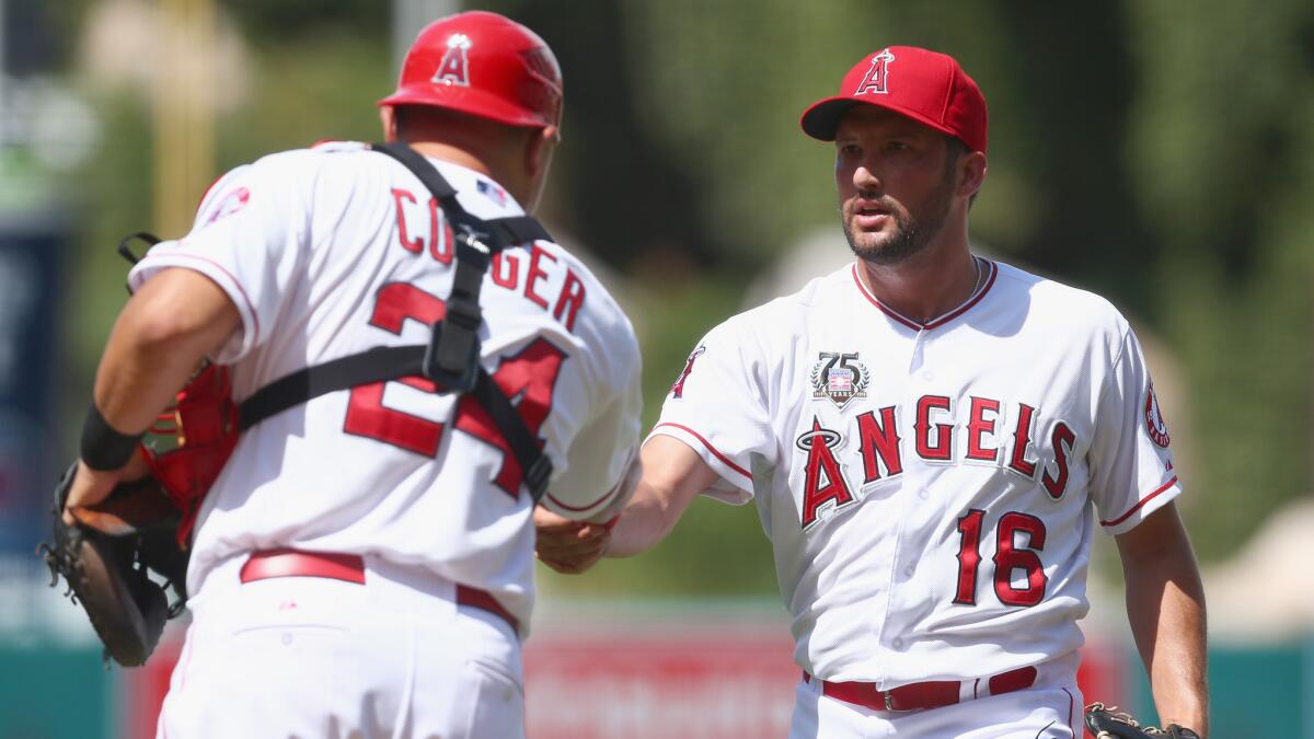 Angels catcher Hank Conger, left, congratulates closer Huston Street following the team's 2-1 win over the Detroit Tigers on Sunday.