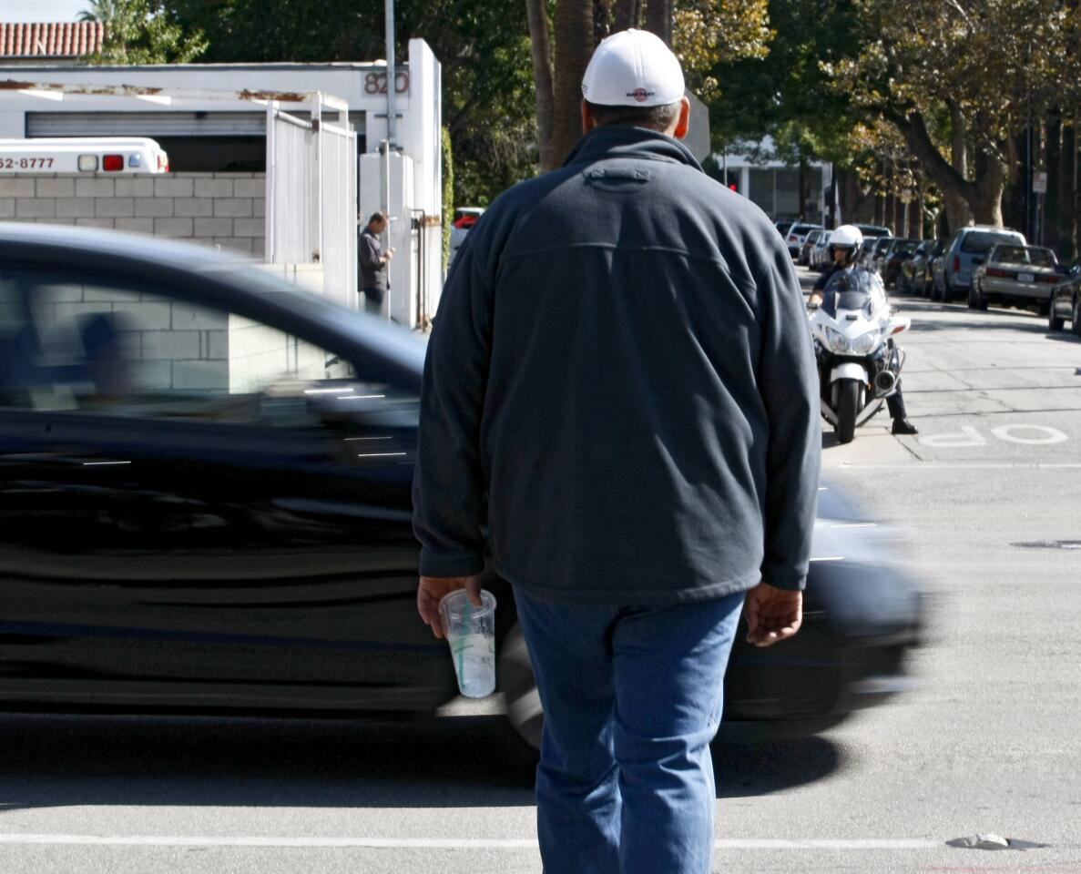 A motorist does not stop for an undecover Glendale Police officer using the crosswalk at Central and Garfield in Glendale on Thursday, Oct. 10, 2013. Drivers who did not stop for the pedestrian were given a citation.