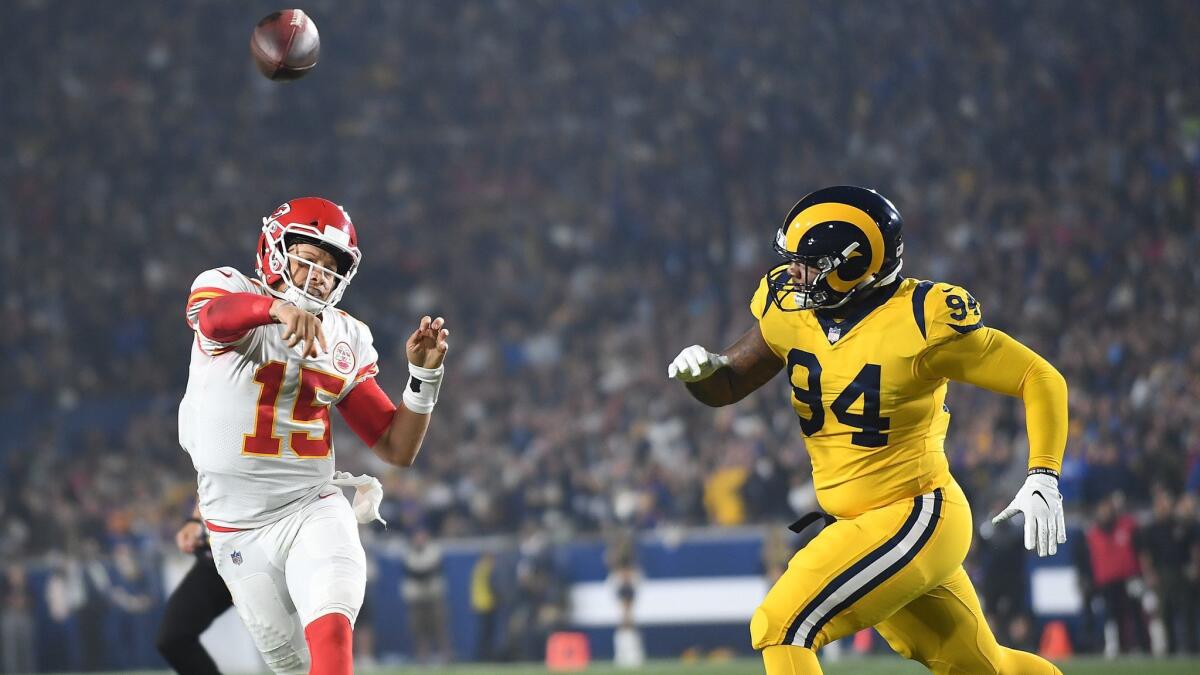 Chiefs quarterback Patrick Mahomes gets a pass off in front of Rams John Franklin-Myers in the second quarter at the Coliseum on Nov. 19, 2018.