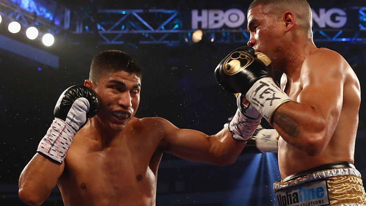 Mikey Garcia, left, connects with a left to the face of Juan Manuel Lopez on June 15, 2013.