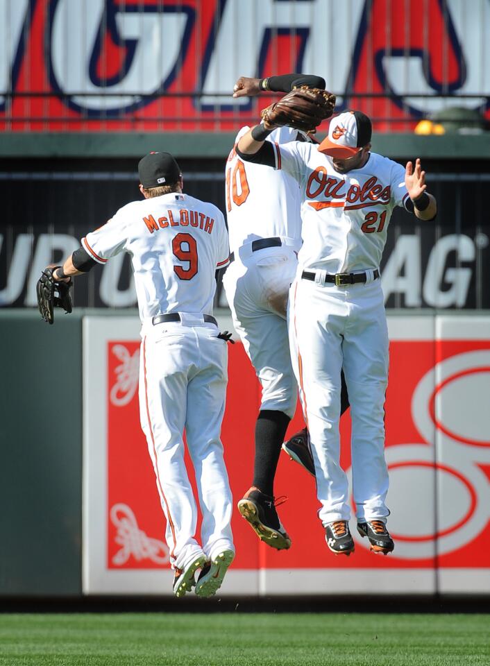 Nate McLouth, Adam Jones and Nick Markakis celebrate the Orioles' 10-3 win over the A's.