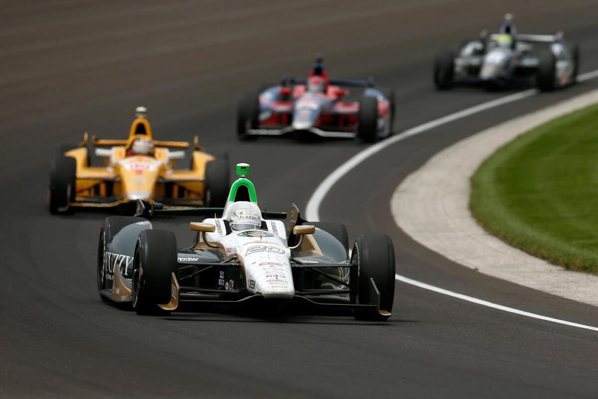 Pole-sitter Ed Carpenter leads a pack of drivers through a turn during the 97th Indianapolis 500 on Sunday.