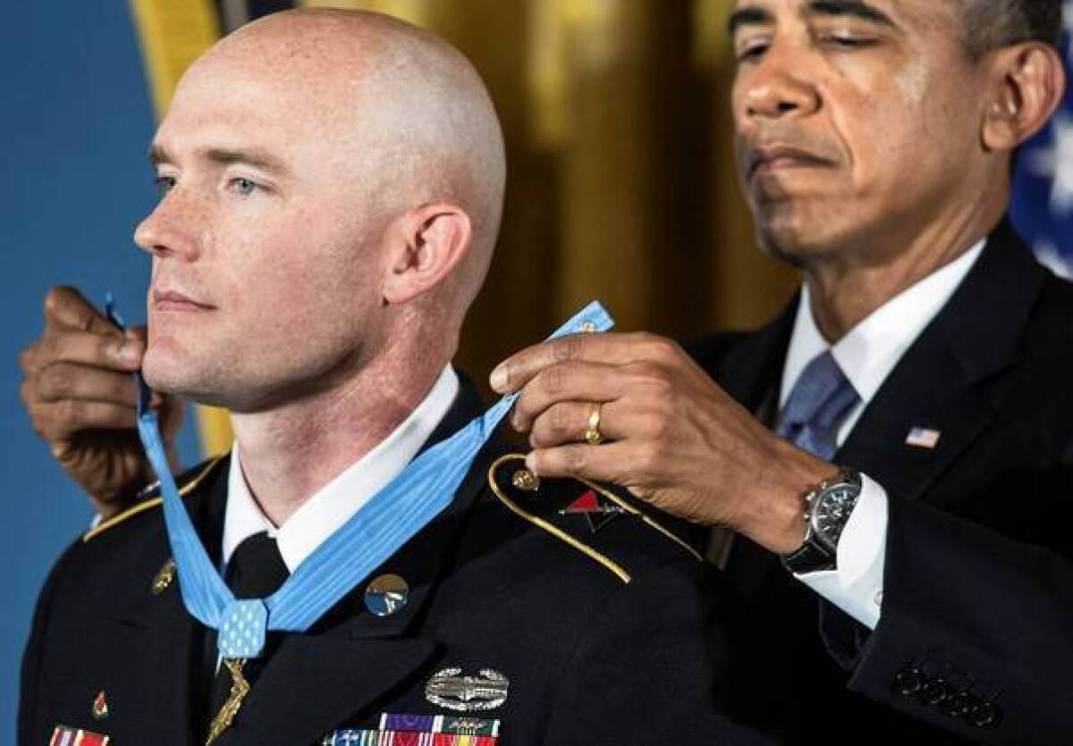 President Obama awards Army Staff Sgt. Ty Carter the Medal of Honor in a ceremony at the White House. Carter, who was cited for valor during a battle in Afghanistan, urged support for soldiers suffering from post-traumatic stress disorder.