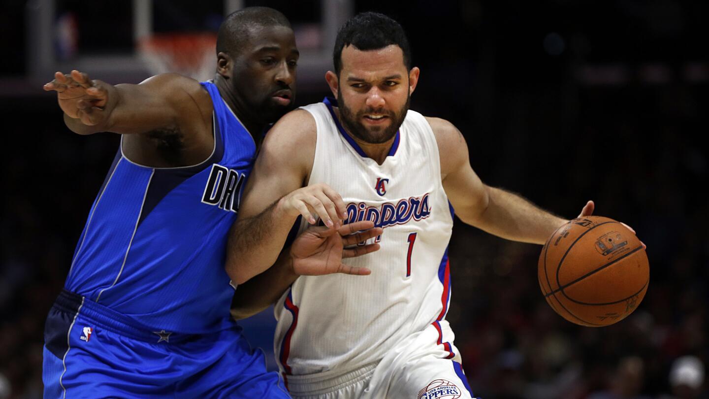 Clippers guard Jordan Farmar, right, tries to drive around Dallas Mavericks guard Raymond Felton during the Clippers' 120-100 win at Staples Center on Jan. 10, 2015.