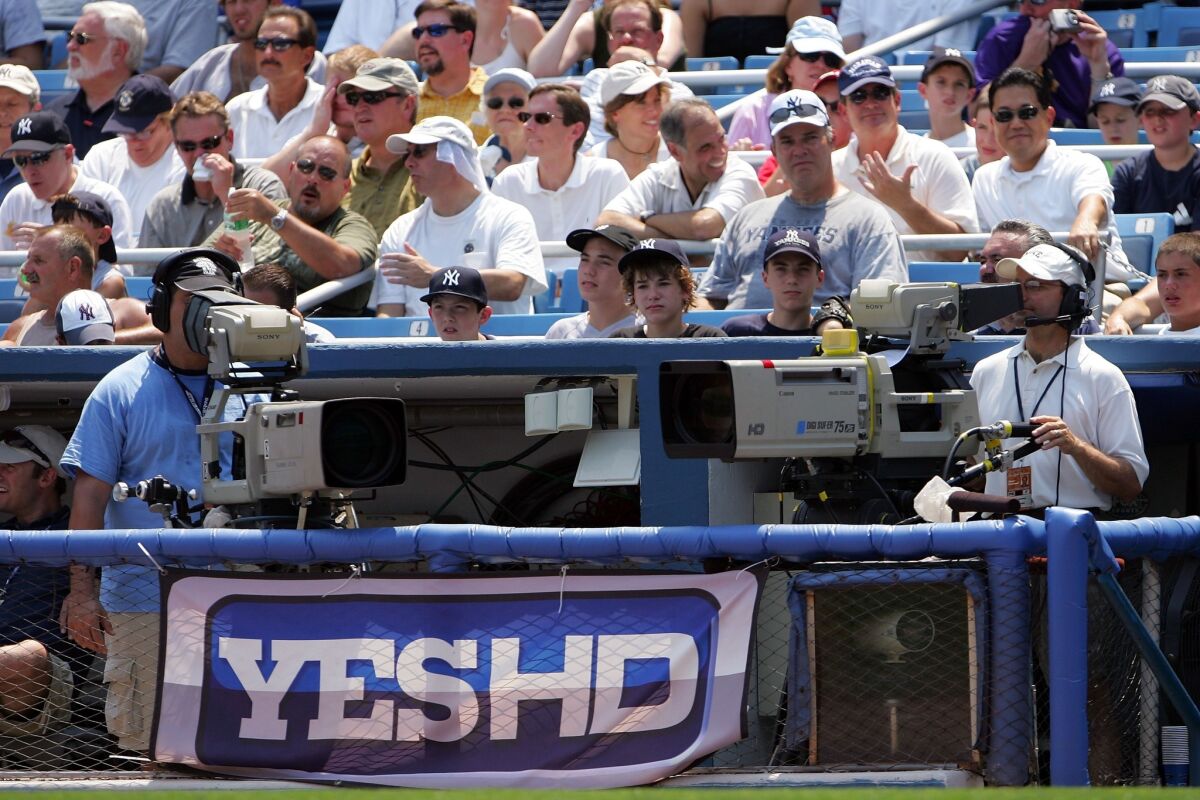 Comcast has dropped the YES Network, which carries New York Yankees baseball games, from its cable TV lineup. Above, a YES banner at Yankee Stadium in 2007.