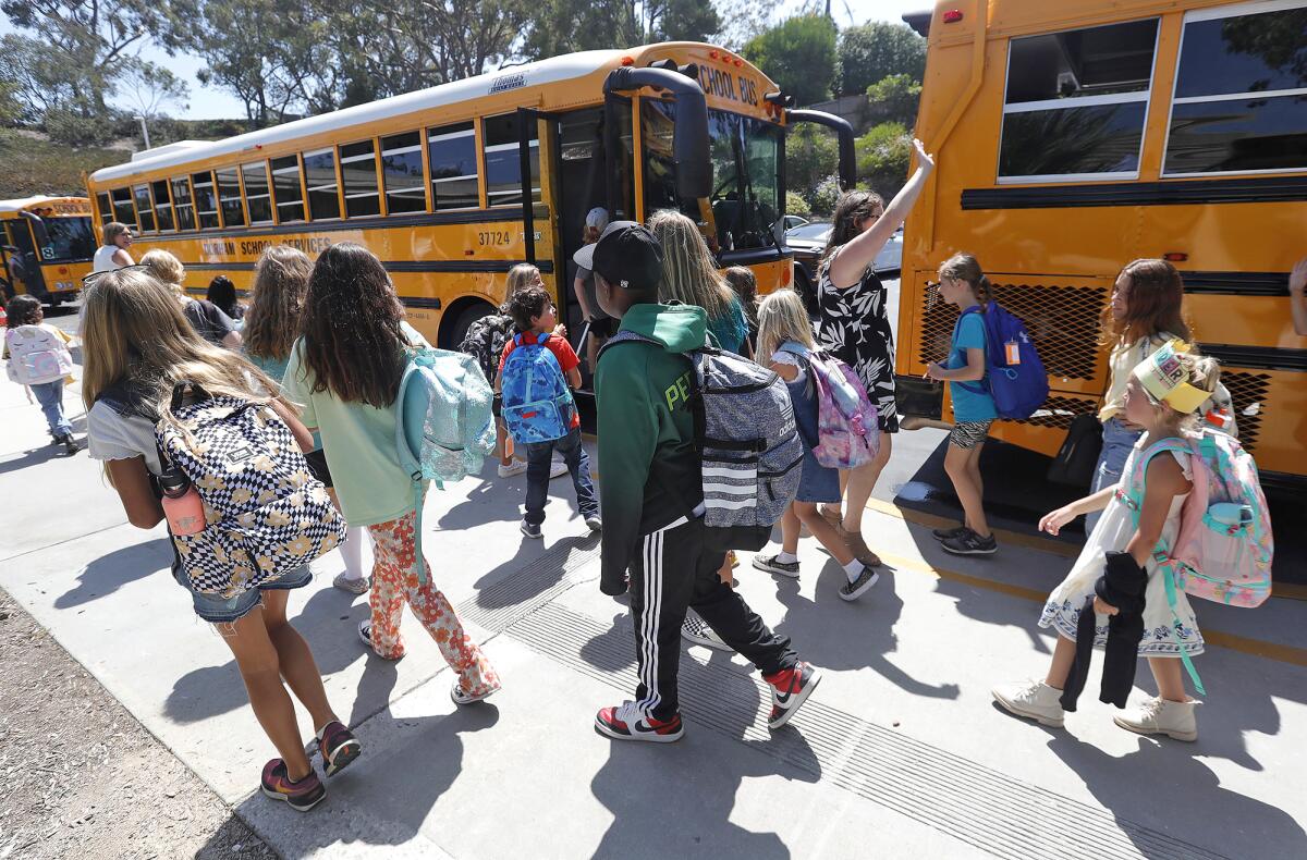 Fourth- and fifth-graders find their home bus during the first day of class at Top of the World Elementary in Laguna Beach.