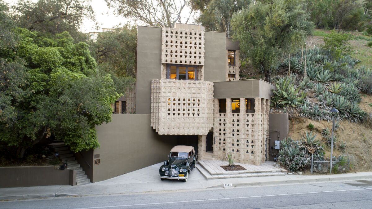 The two-story home showcases Mayan-inspired style such as intricate designs and dramatic concrete blocks.