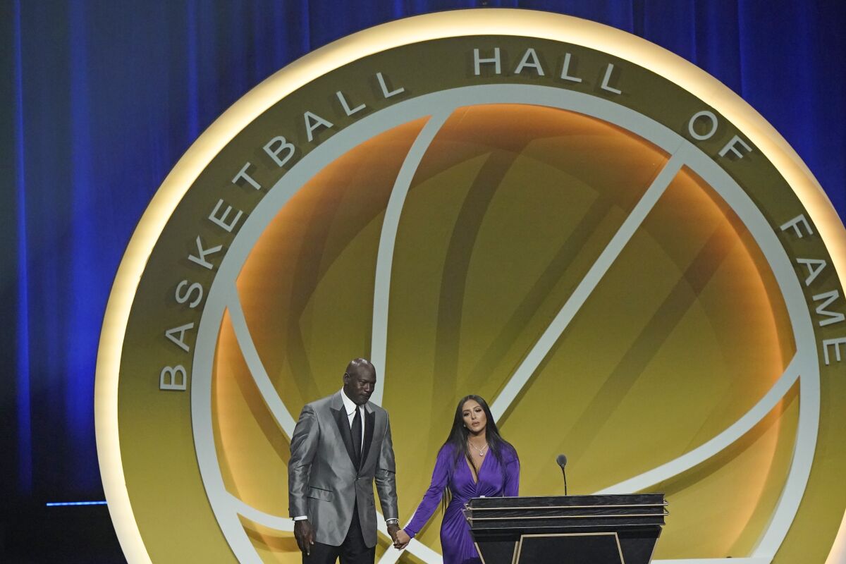 Michael Jordan, left, holds the hand of Vanessa Bryant after Kobe Bryant was enshrined in the Hall of Fame
