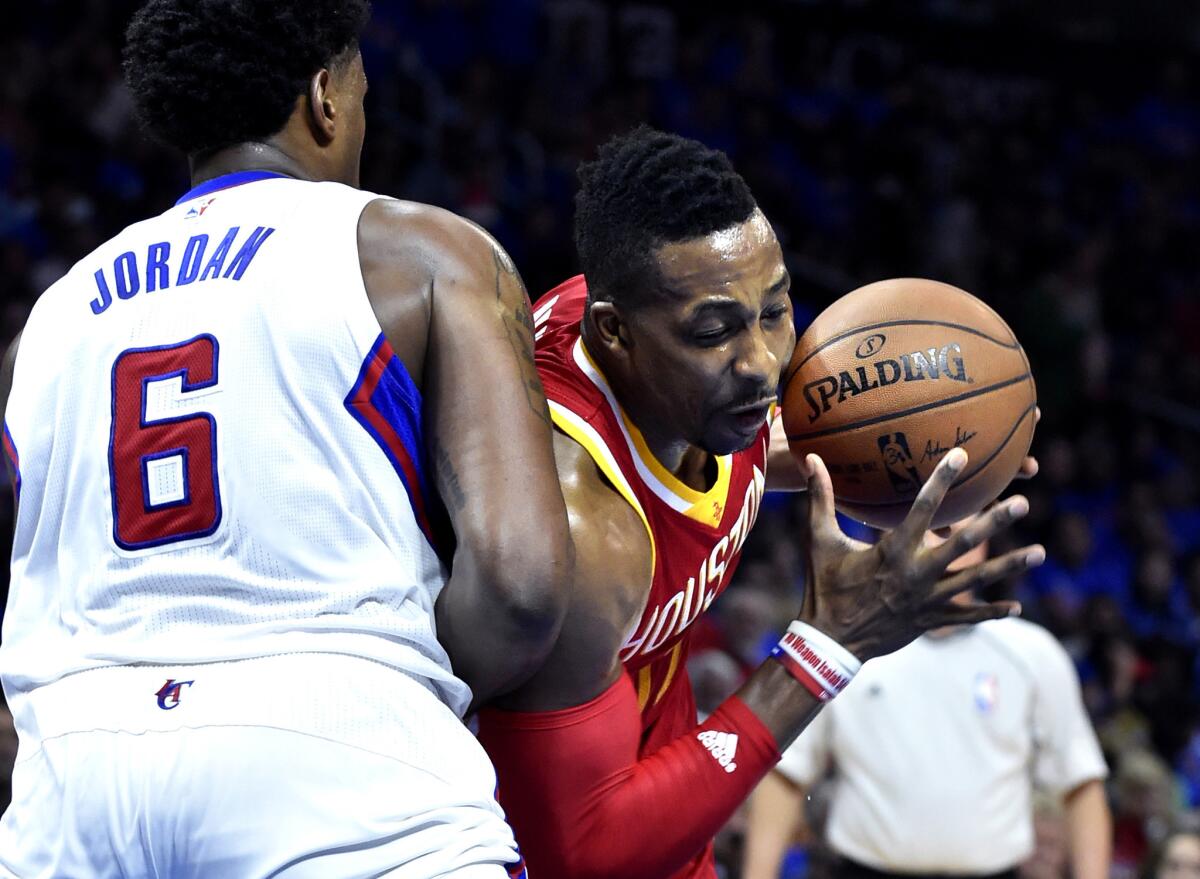 Rockets center Dwight Howard loses control of the ball as he tries to drive against Clippers center DeAndre Jordan during Game 4.